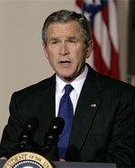 President George W. bush speaking at the podium.