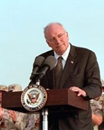 Vice President Dick Cheney speaking at the podium before the troops in Qatar on March 17, 2005.